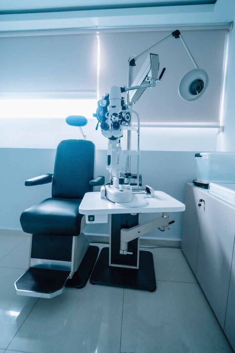 A modern optometry examination room with an ophthalmic chair and slit lamp.