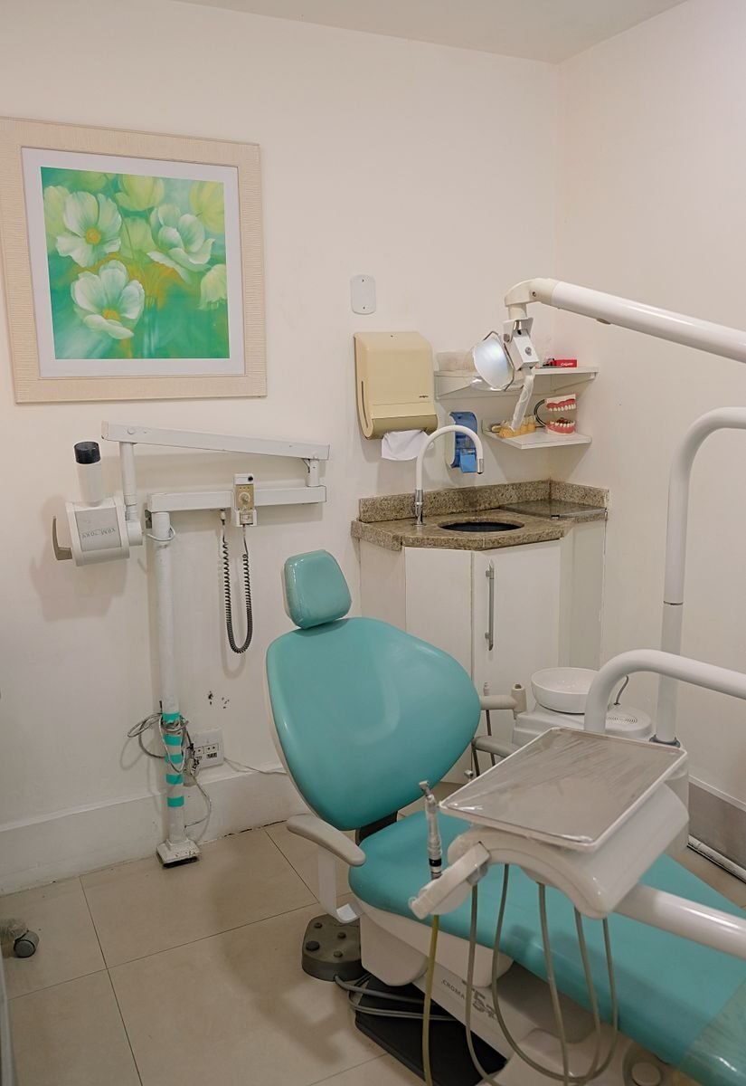 Bright and clean modern dentist office interior with dental chair and equipment.